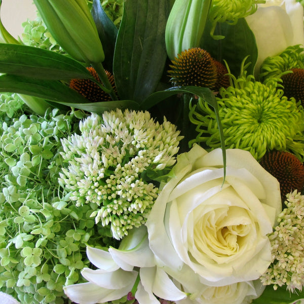 Flowers used: white roses, white lilies, white sedums, green chrysanthemums, green hydrangeas, pink sedums