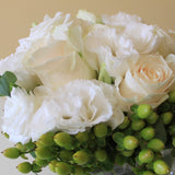 Flowers used: white roses, white lisianthus, green hypericum berries