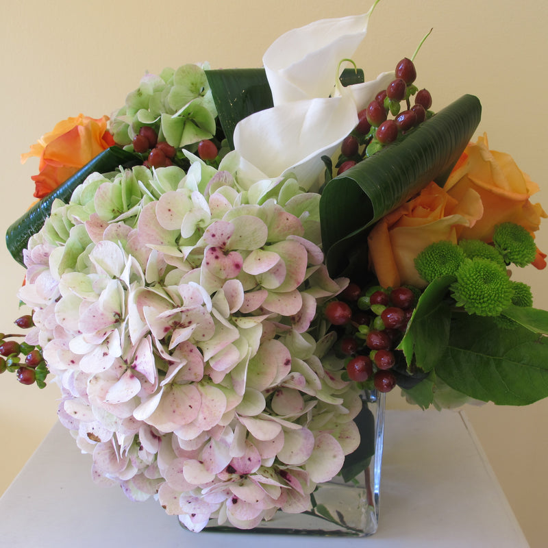 Flowers used: orange roses, white calla lilies, mauve hydrangeas, hypericum berries