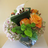 Flowers used: orange roses, white calla lilies, mauve hydrangeas, hypericum berries