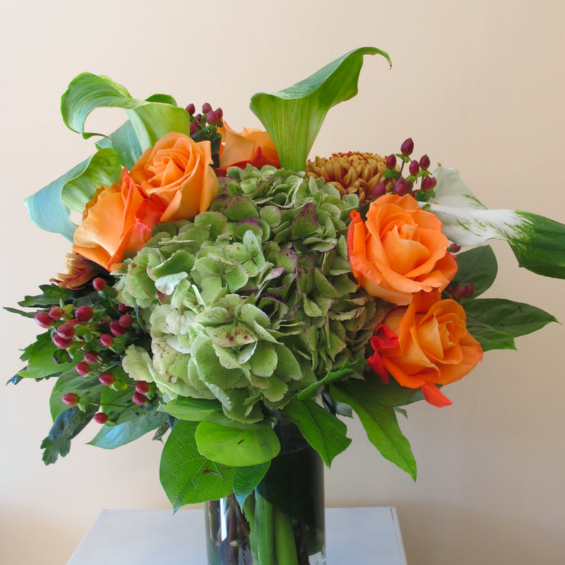 Flowers used: orange roses, green calla lilies, green hydrangeas, hypericum berries