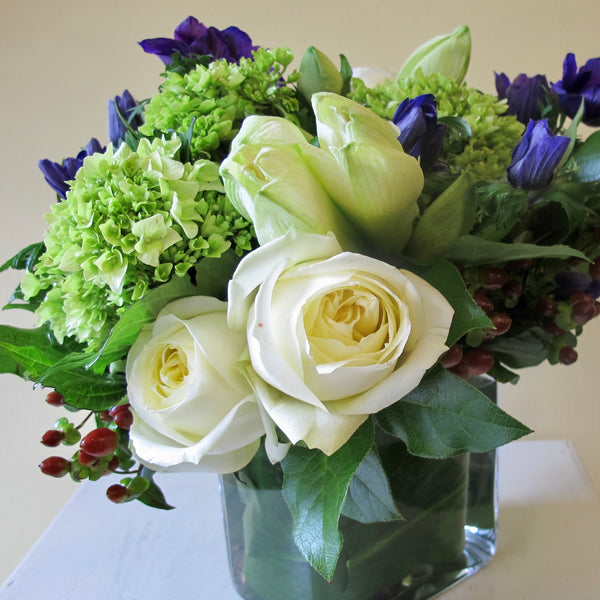 Flowers used: white roses, blue anemones, white amaryllis, green hydrangeas, red hypericum berries