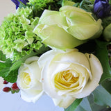 Flowers used: white roses, blue anemones, white amaryllis, green hydrangeas, red hypericum berries