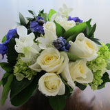 Flowers used: cream white roses, blue anemones, purple hyacinths, white orchids