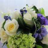 Flowers used: cream white roses, blue anemones, purple hyacinths, white orchids