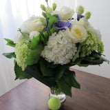 Flowers used: white roses, green and white hydrangeas, green chrysanthemums, purple ranunculus, white lisianthus