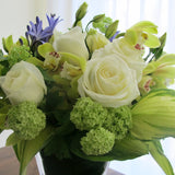 Flowers used: white roses, green viburnum, chartreuse cymbidium orchids, blue agapanthus