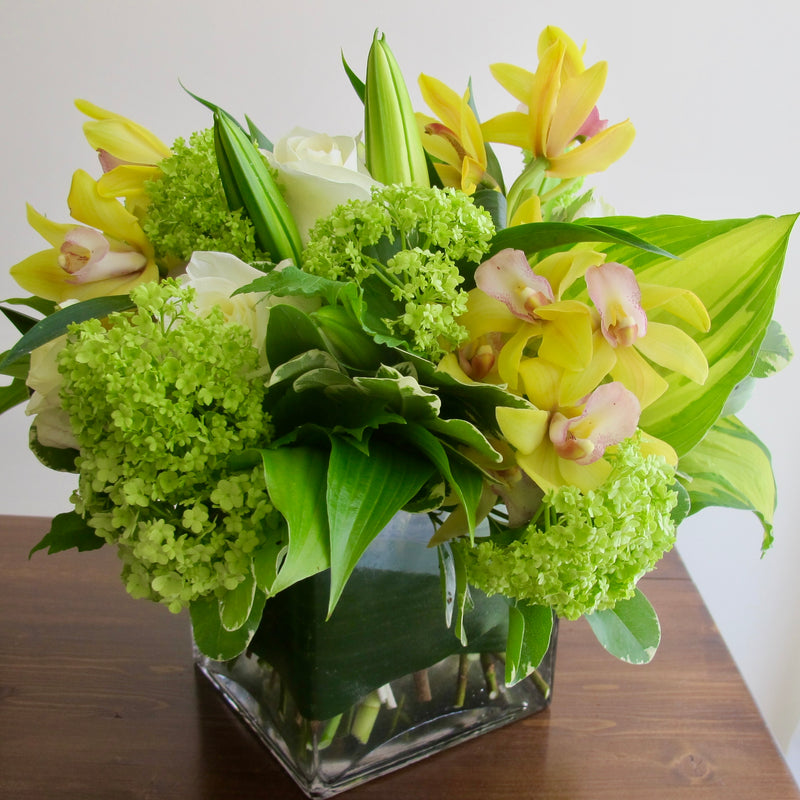 Flowers used: white roses, green viburnum, white lilies, yellow orchids