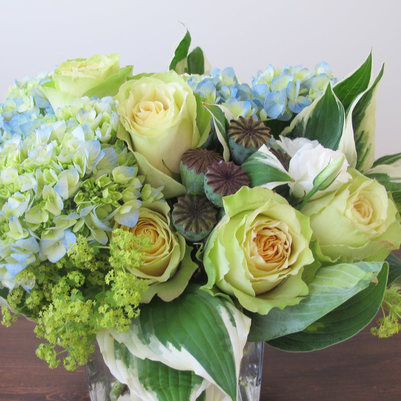 Flowers used: chartreuse roses, white lisianthus, blue blush hydrangeas, chartreuse lady’s mantles, poppy seed pods