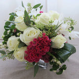 Flowers used: white roses, white orchids, pink celosias, seeded eucalyptus, white berries