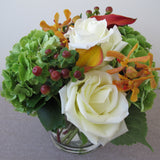 Flowers used: white roses, orange calla lilies, orange mokara orchids, green hydrangeas, hypericum berries