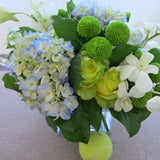 Flowers used: white roses, blue hydrangeas, white orchids, green mini mums