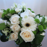 Flowers used: white roses, white gerberas, white orchids, green mini mums