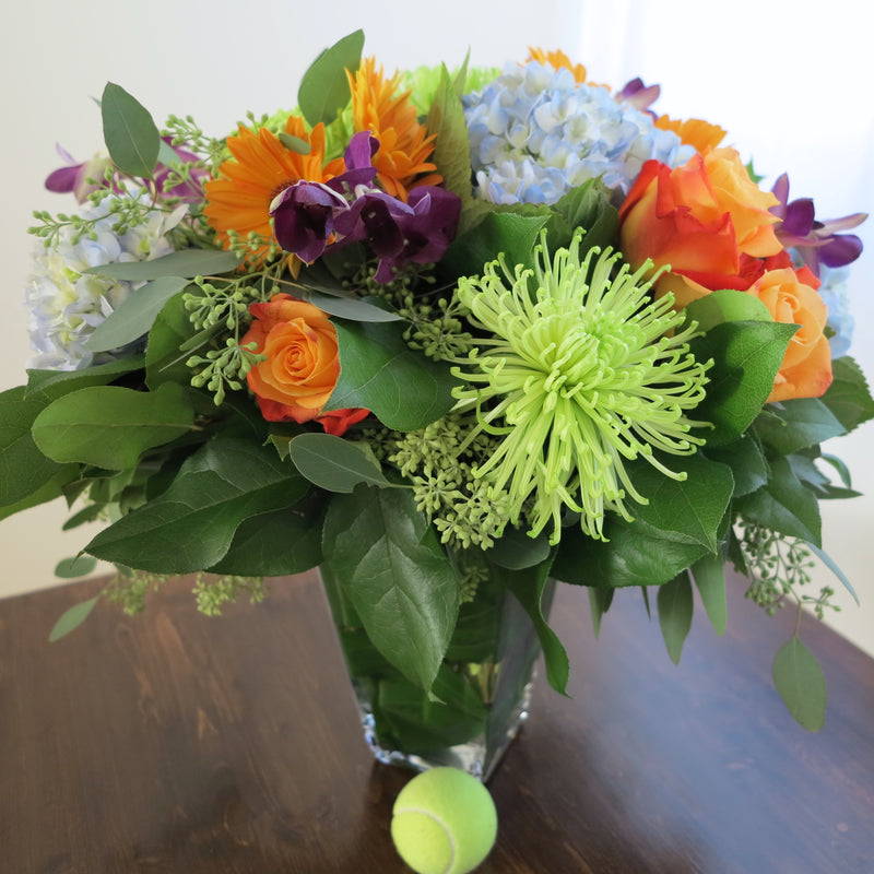 Flowers used: orange roses, orange gerberas, blue hydrangeas, green chrysanthemums, purple orchids, seeded eucalyptus
