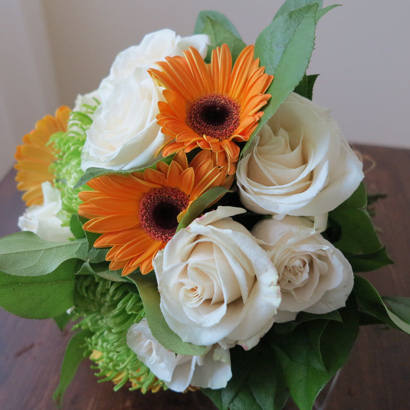 Flowers used: cream roses, orange gerberas, green mums