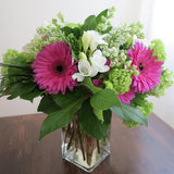 Flowers used: white freesias, lavender pink gerberas, white lilacs, green viburnums