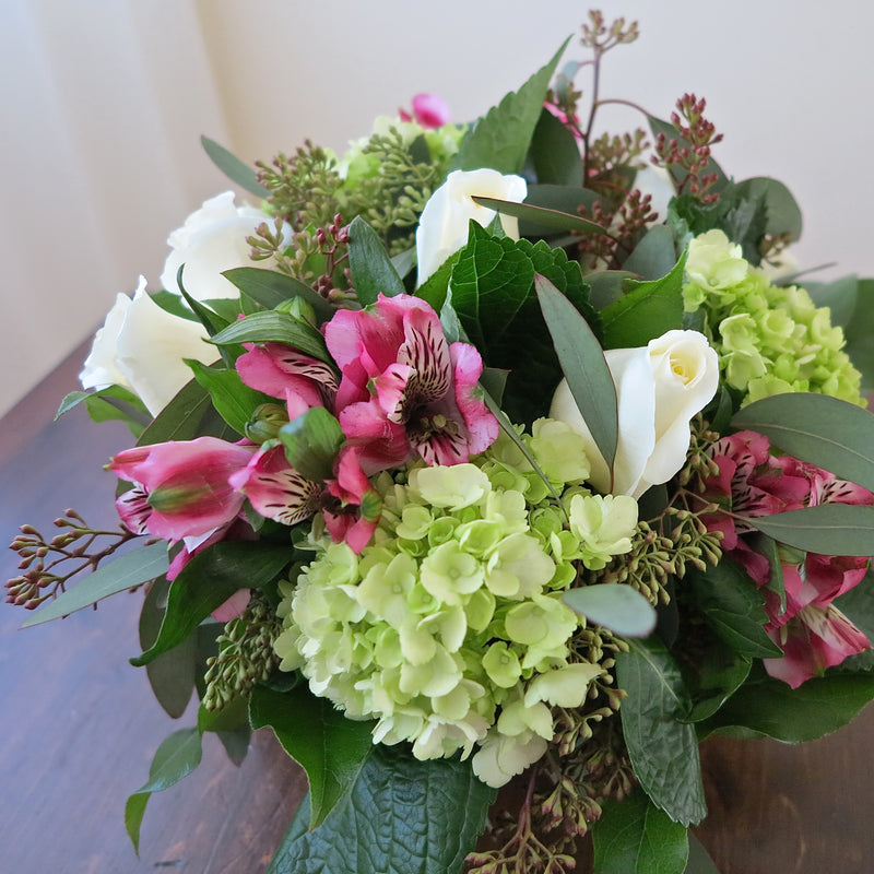 Flowers used: white roses, pink alstroemerias, green hydrangeas, seeded eucalyptus