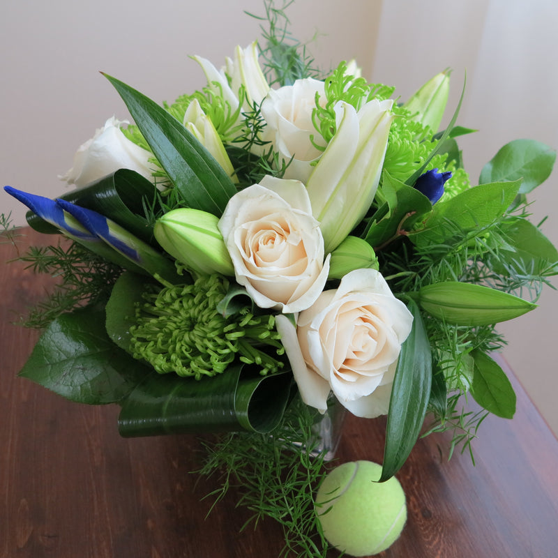 Flowers used: cream roses, white lilies, green chrysanthemums, blue irises