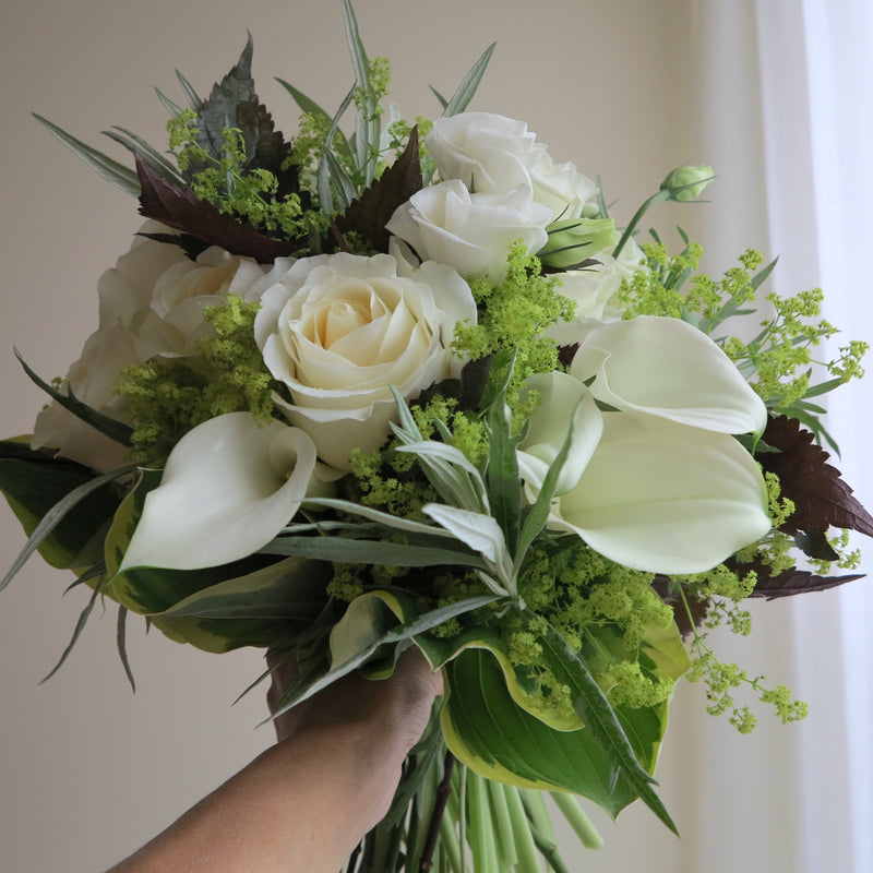 Flowers used: white roses, white calla lilies, white lisianthus, chartreuse lady's mantle