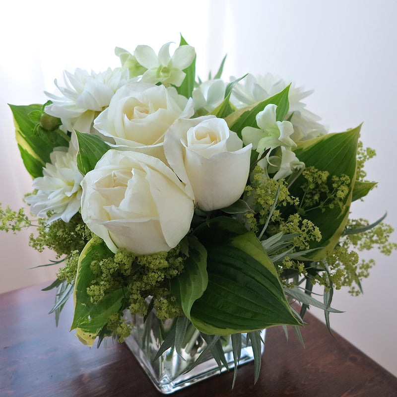 Flowers used: white roses, white dahlias, white orchids, chartreuse lady's mantle, hosta leaves