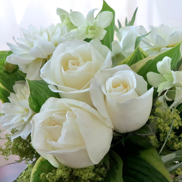Flowers used: white roses, white dahlias, white orchids, chartreuse lady's mantle, hosta leaves
