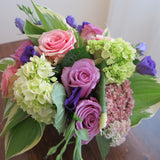 Flowers used: green hydrangeas, pink and mauve roses, blue lisianthus, pink sedums, hosta leaves