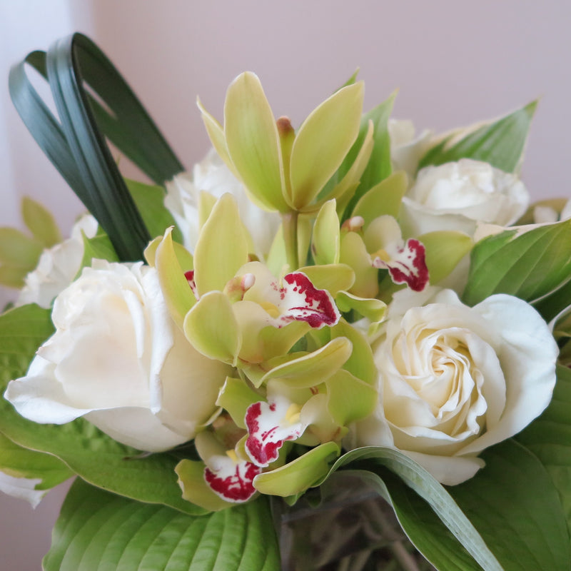 Flowers used: white roses, chartreuse cymbidium orchids, hosta leaves
