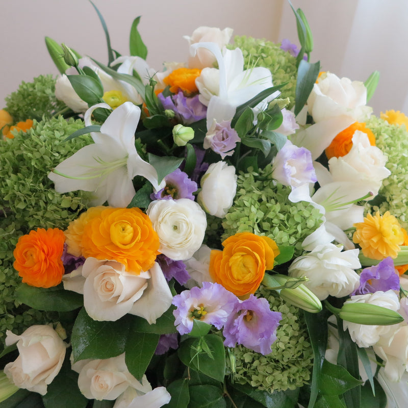 Flowers used: cream roses, white lilies, green hydrangeas, white ranunculus  and purple lisianthus