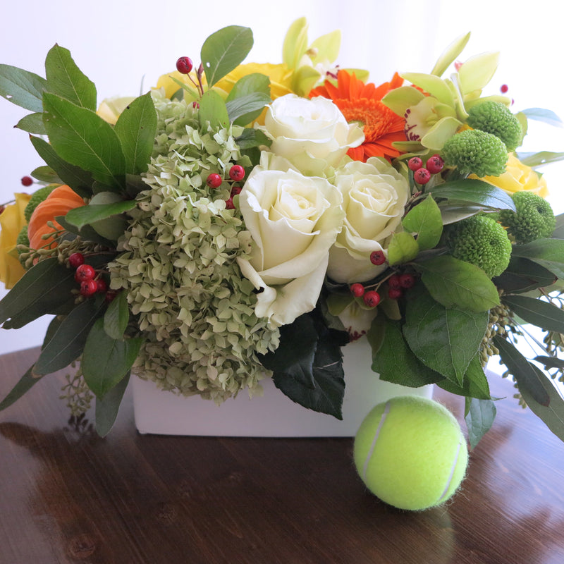 Flowers used: yellow roses, orange gerberas and gourds, green mums, orchids and hydrangeas, red rose hips and chartreuse seeded eucalyptus