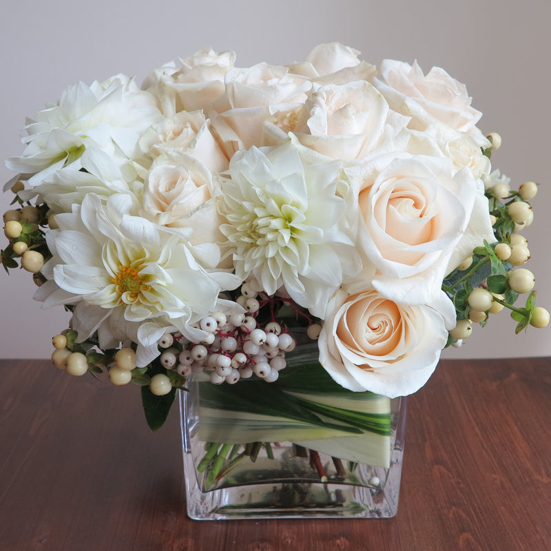 Flowers used: cream roses, white orchids and dahlias adored by white hypericum and dogwoods berries