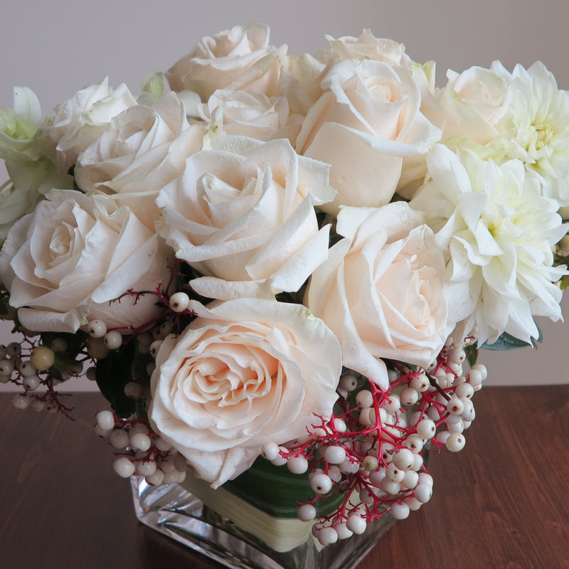 Flowers used: cream roses, white orchids and dahlias adored by white hypericum and dogwoods berries