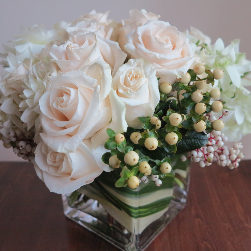 Flowers used: cream roses, white orchids and dahlias adored by white hypericum and dogwoods berries
