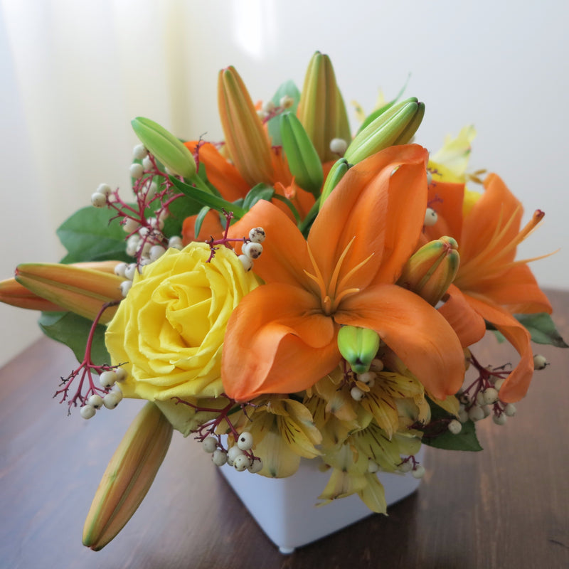 Flowers used: orange lilies, yellow roses, yellow alstroemerias, fall berries