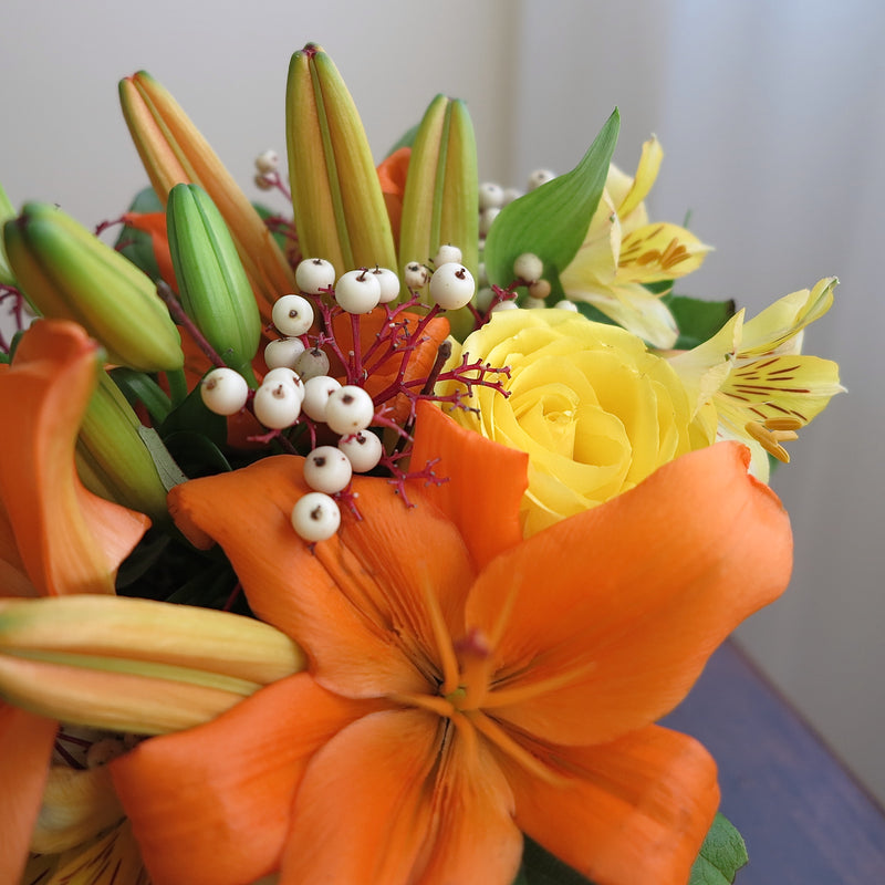 Flowers used: orange lilies, yellow roses, yellow alstroemerias, fall berries