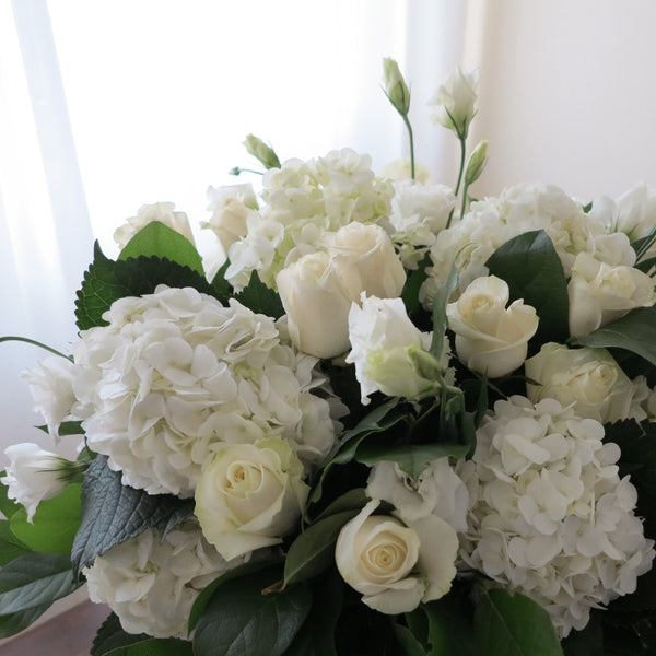 Flowers used: white roses, white hydrangeas, white lisianthus