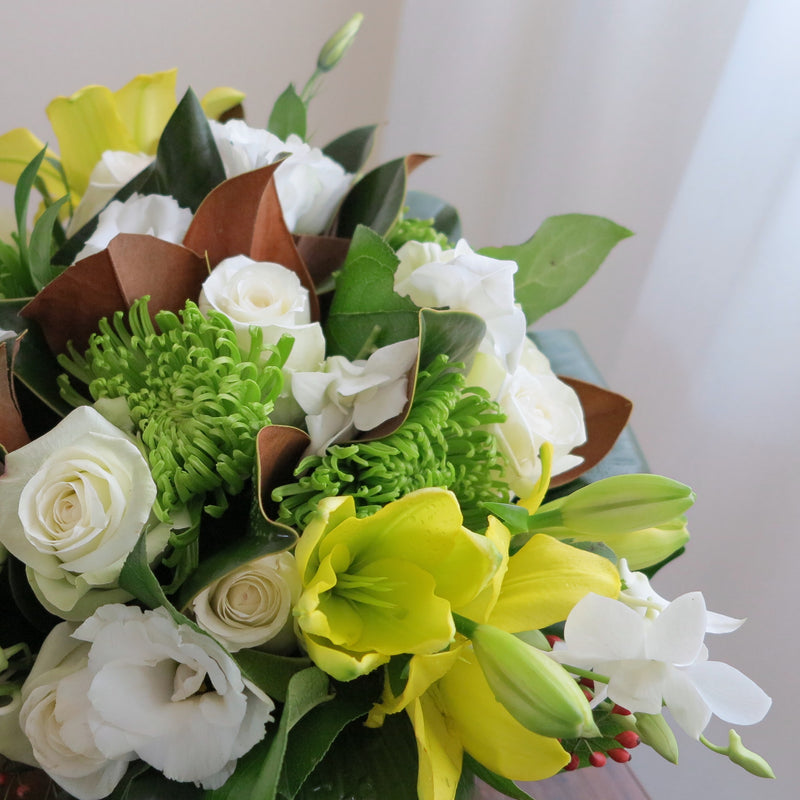 Flowers used: yellow lilies, green chrysanthemums, white roses, white orchids, white lisianthus