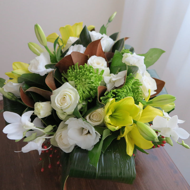 Flowers used: yellow lilies, green chrysanthemums, white roses, white orchids, white lisianthus