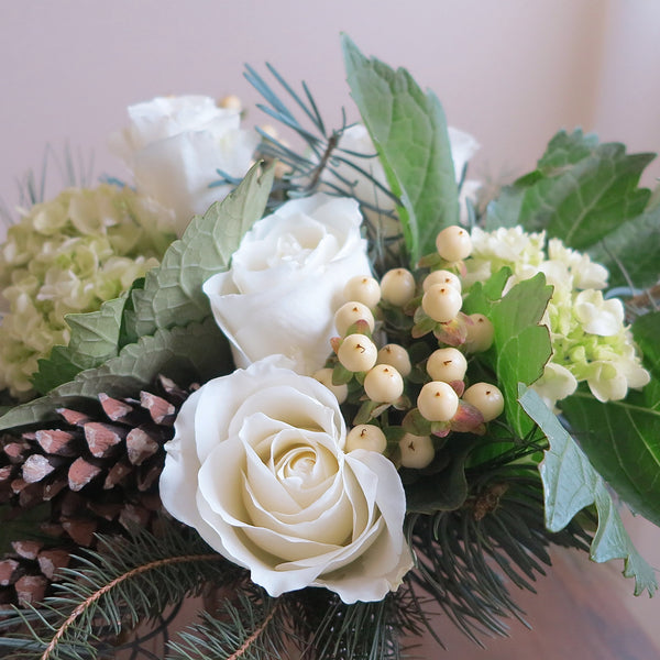 Flowers uses: white roses, red roses, chartreuse hydrangea, white hypericum berries, white pine cones