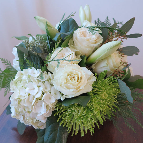 Flowers used: cream roses, white amaryllis, white hydrangeas, green chrysanthemums and seeded eucalyptus