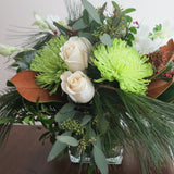 Flowers used: white orchids and white roses, green chrysanthemums, magnolia leaves, seeded eucalyptus, white pine