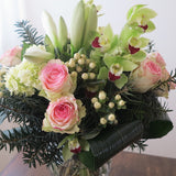 Flowers used:  pink roses, chartreuse cymbidium orchids , white amaryllis, white hypericum berries, evergreens boughs