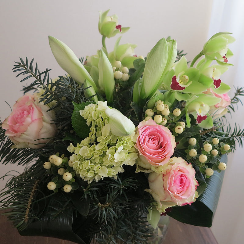 Flowers used:  pink roses, chartreuse cymbidium orchids , white amaryllis, white hypericum berries, evergreens boughs