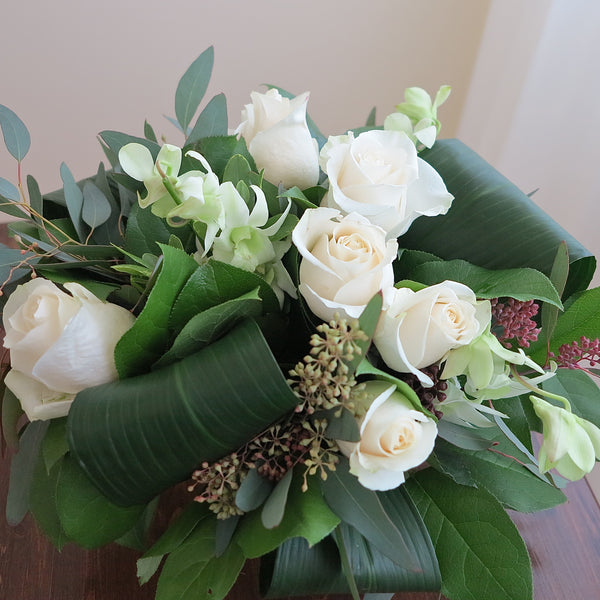 Flowers used: white orchids, white roses, seeded eucalyptus