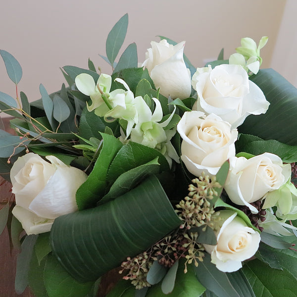 Flowers used: white orchids, white roses, seeded eucalyptus
