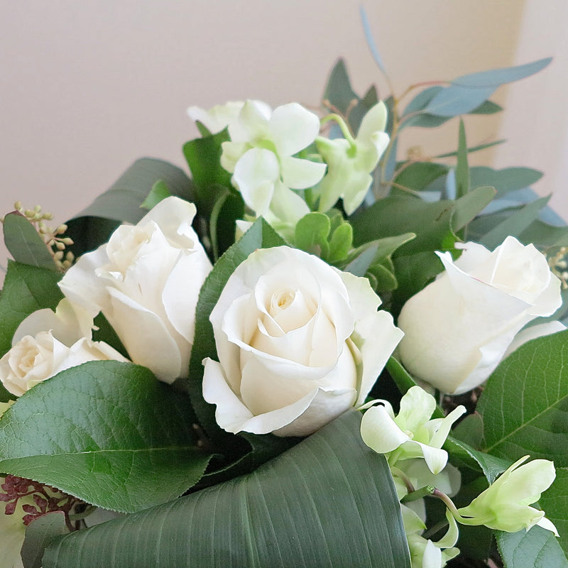 Flowers used: white orchids, white roses, seeded eucalyptus