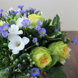 Flowers used: yellow/chartreuse roses, blue asters, white freesias