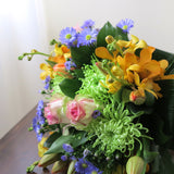 Flowers used: orange orchids, blush pink roses, green mums, red tulips and blue daisies