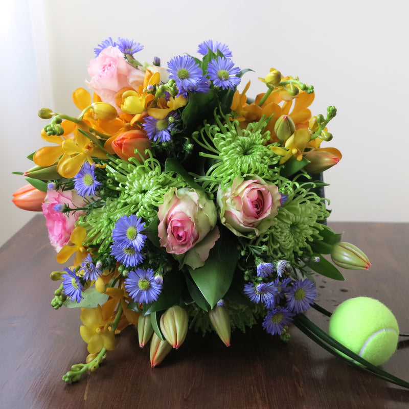Flowers used: orange orchids, blush pink roses, green mums, red tulips and blue daisies