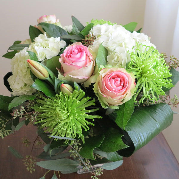 Flowers used: pink blush roses, green chrysanthemums, red tulips, white hydrangeas, seeded eucalyptus