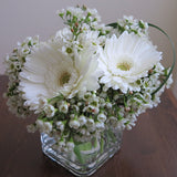 Flowers used: white gerberas, white wax flowers